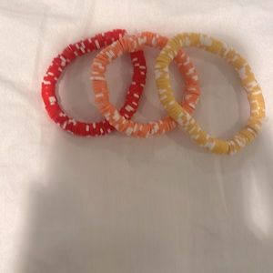 Set of three bracelets alduts or kid a bit small but stretchy warm colors